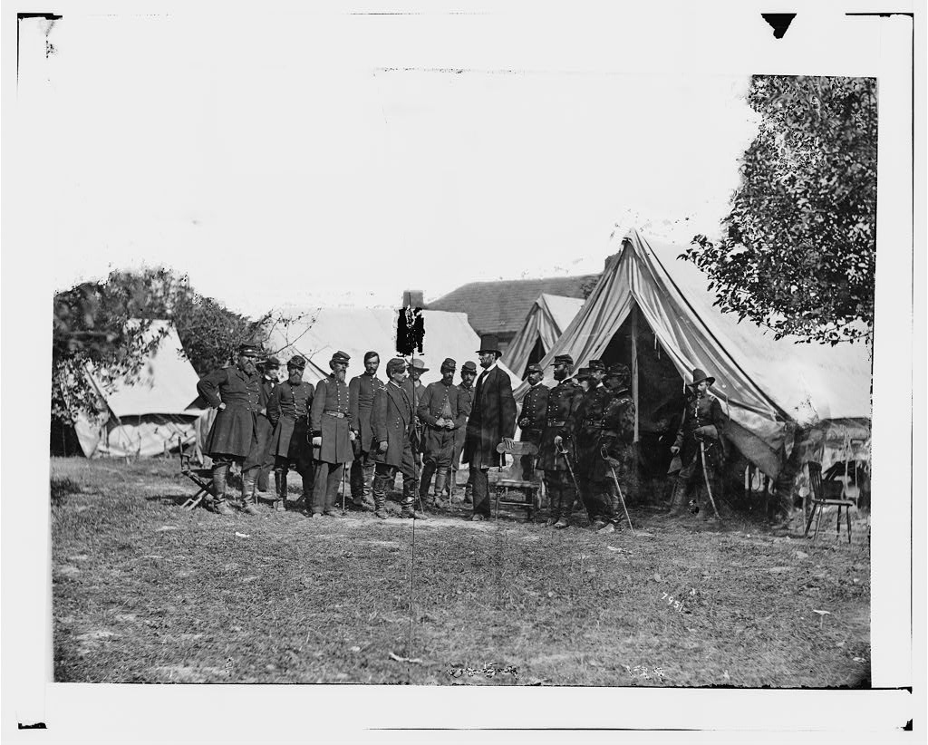 Abraham Lincoln standing across from General George B. McClellan and Union officers beside a tent at Antietam in October 1862