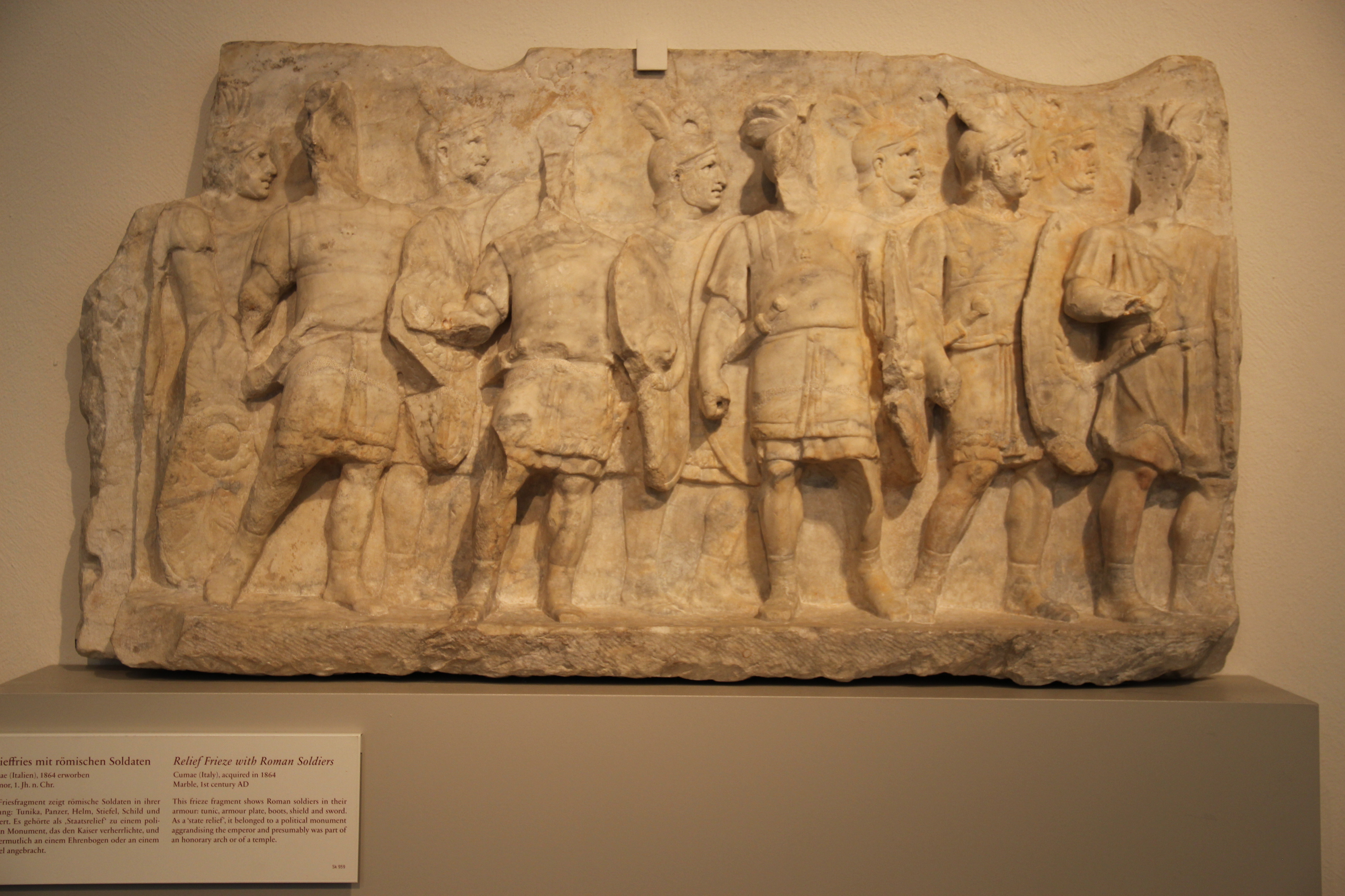 Ancient marble relief showing a row of Roman soldiers with shields